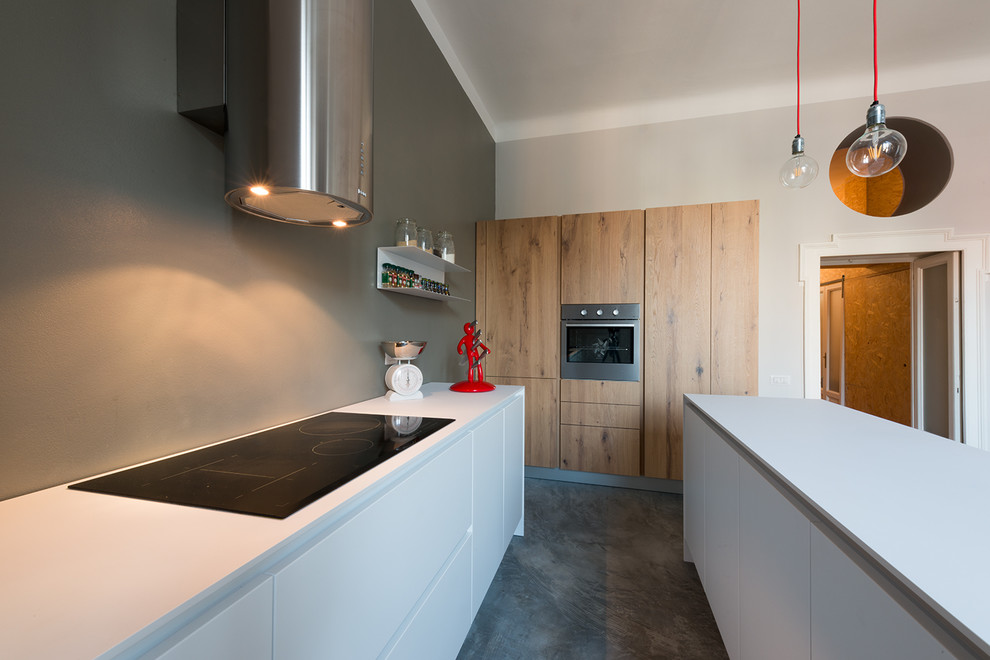 Esempio di una cucina minimal di medie dimensioni con lavello a vasca singola e pavimento in cemento