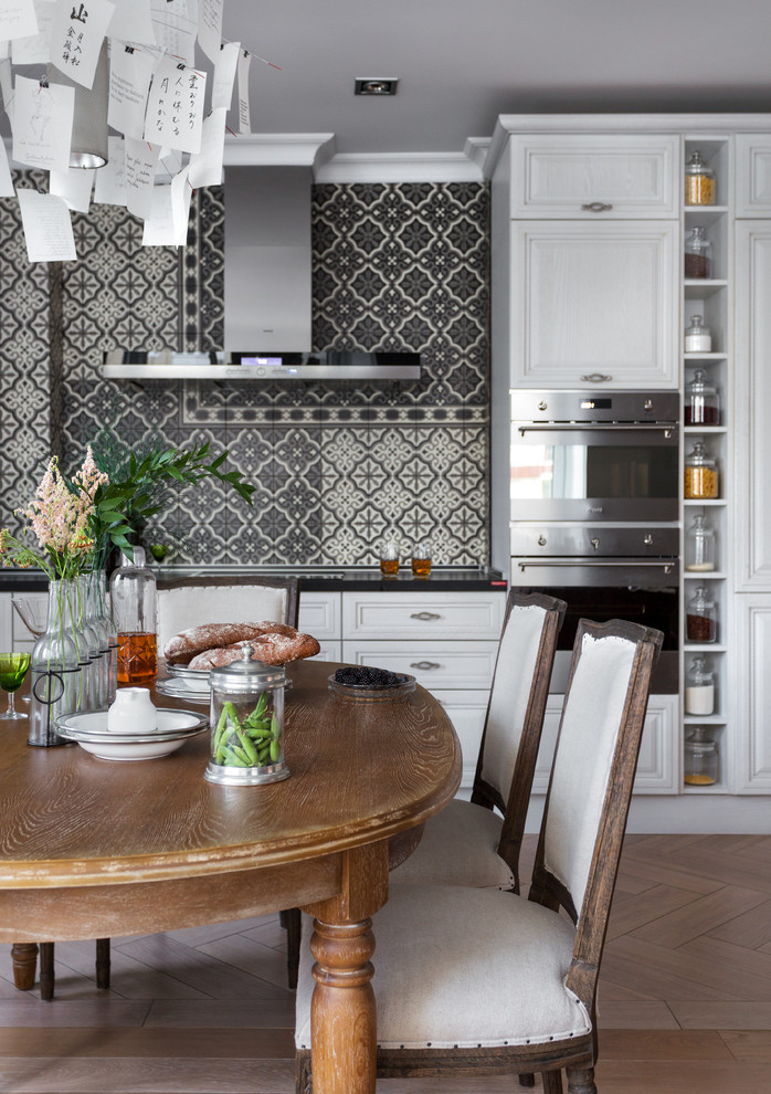 Medium sized traditional kitchen/diner in Moscow with stainless steel appliances, porcelain flooring, beige floors, black worktops and grey splashback.