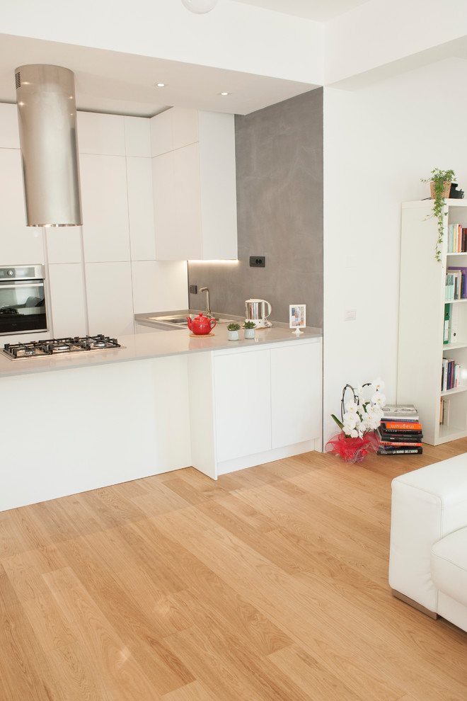 Photo of a medium sized modern l-shaped open plan kitchen in Rome with louvered cabinets, white cabinets, quartz worktops, painted wood flooring, an island and yellow floors.