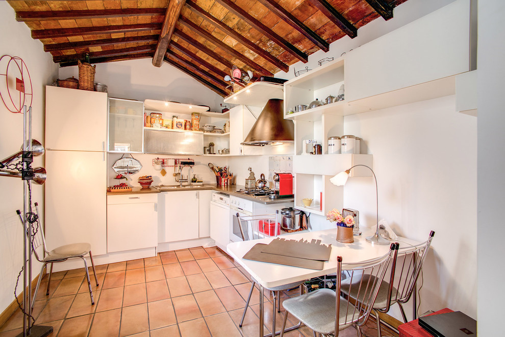 Foto di una piccola cucina a L eclettica con ante lisce, elettrodomestici colorati e pavimento in terracotta