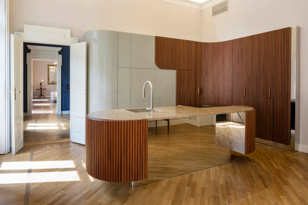 Photo of a large contemporary l-shaped enclosed kitchen in Milan with an island, a submerged sink, flat-panel cabinets, dark wood cabinets, marble worktops, light hardwood flooring and brown floors.