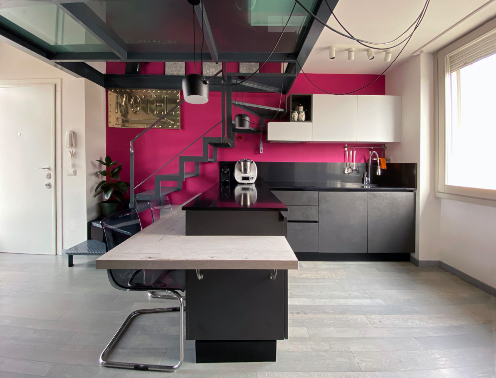 Example of a small trendy l-shaped gray floor eat-in kitchen design in Milan with flat-panel cabinets, gray cabinets, black backsplash, an island, black countertops, a single-bowl sink, quartz countertops and quartz backsplash
