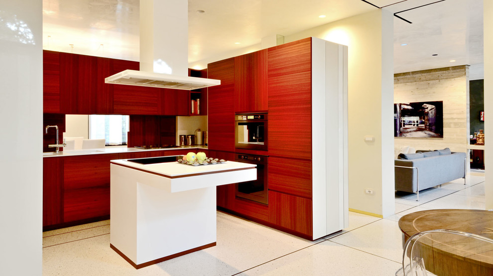 Immagine di una cucina moderna con lavello integrato, ante in legno scuro, top in superficie solida, elettrodomestici in acciaio inossidabile e pavimento in marmo