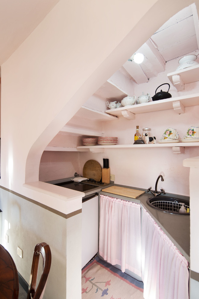 This is an example of a rural kitchen in Milan with a built-in sink.