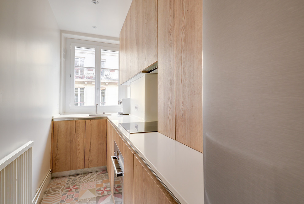 Photo of a medium sized traditional l-shaped enclosed kitchen in Paris with a submerged sink, beaded cabinets, medium wood cabinets, quartz worktops, white splashback, integrated appliances, ceramic flooring and no island.