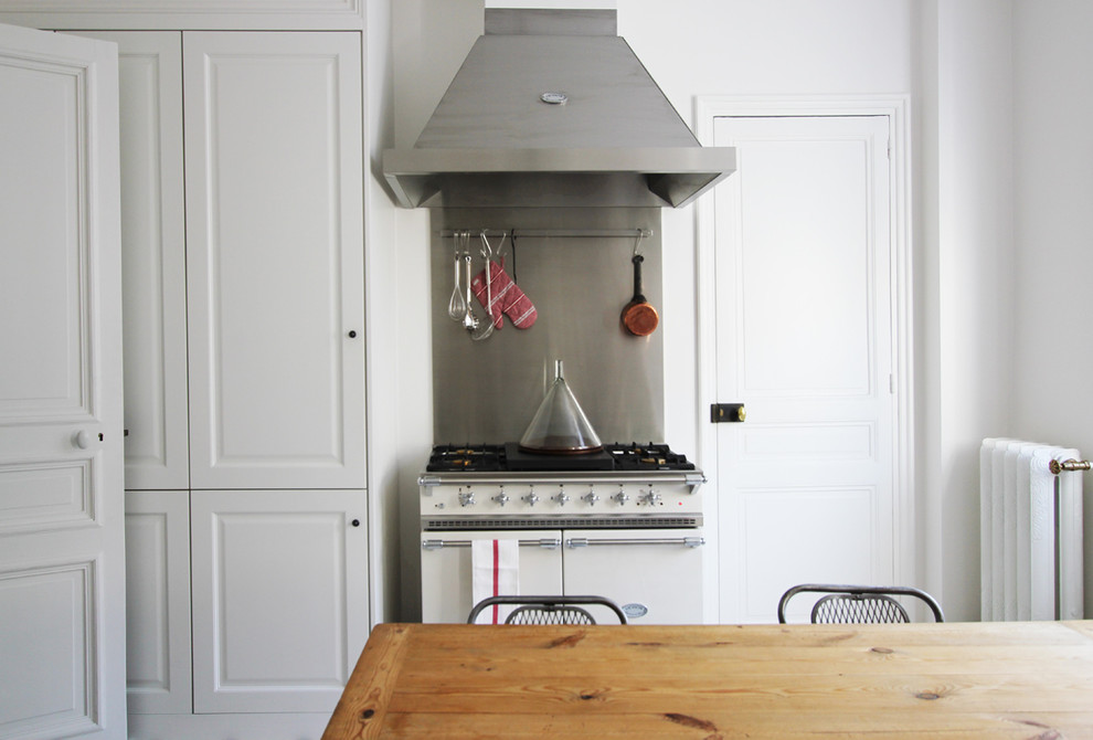 Стильный дизайн: прямая кухня среднего размера в стиле ретро с деревянной столешницей, обеденным столом и белой техникой - последний тренд