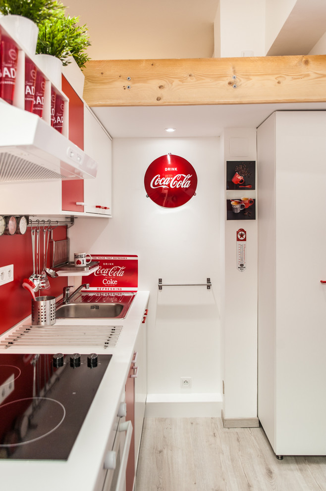 Inspiration for a small classic single-wall open plan kitchen in Toulouse with an integrated sink, red cabinets, wood worktops, red splashback, ceramic splashback, white appliances, light hardwood flooring and no island.