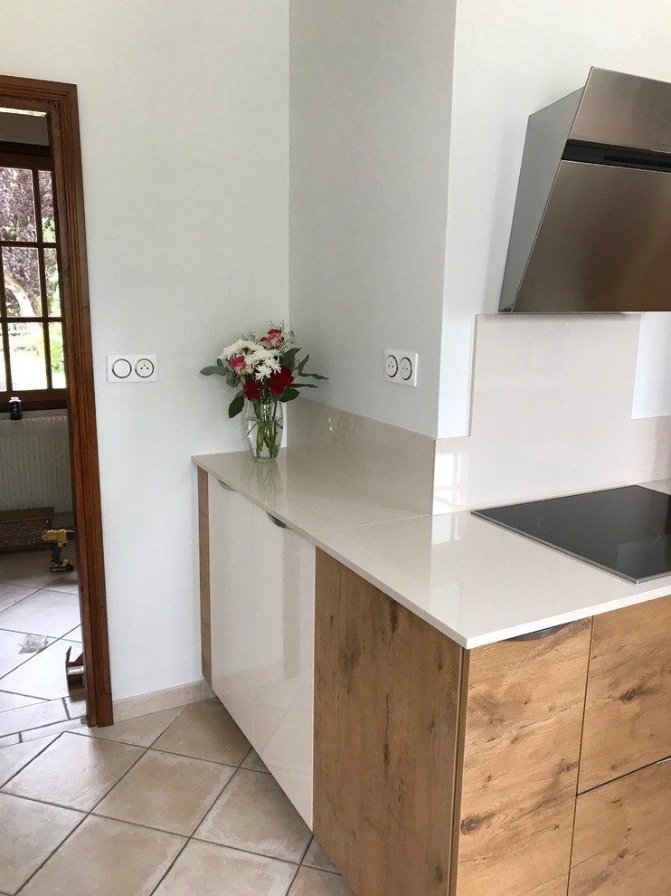 Large farmhouse u-shaped enclosed kitchen in Other with an integrated sink, flat-panel cabinets, medium wood cabinets, composite countertops, beige splashback, black appliances, ceramic flooring, no island, beige floors and beige worktops.