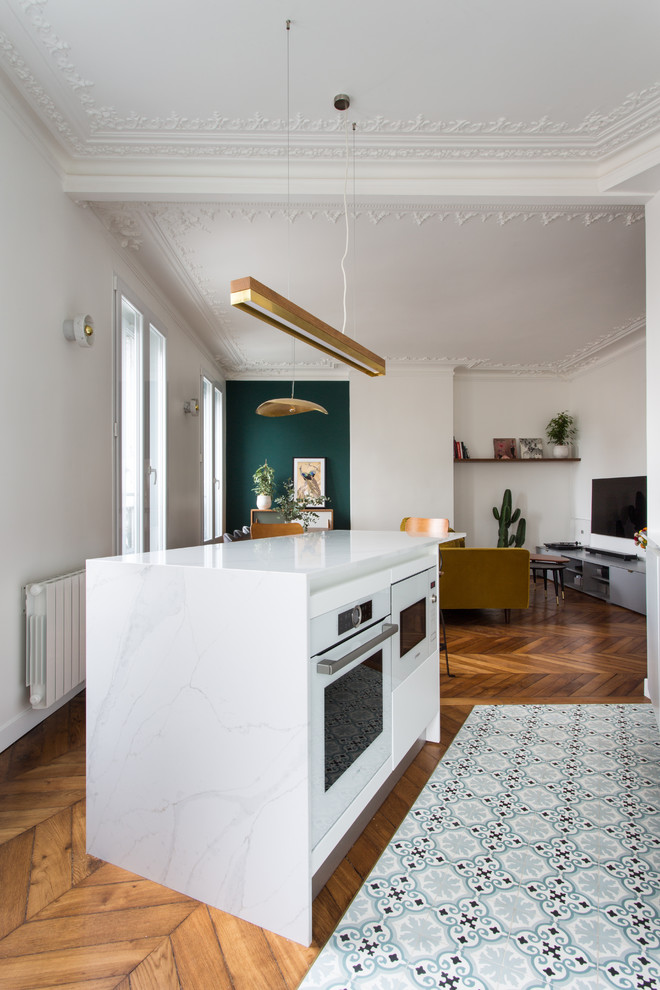 Medium sized retro single-wall open plan kitchen in Paris with marble worktops, blue splashback, ceramic splashback, cement flooring, an island, blue floors and white worktops.