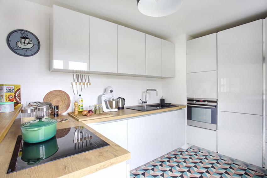 Design ideas for a large scandi l-shaped open plan kitchen in Paris with white cabinets, wood worktops, white splashback, ceramic flooring and no island.