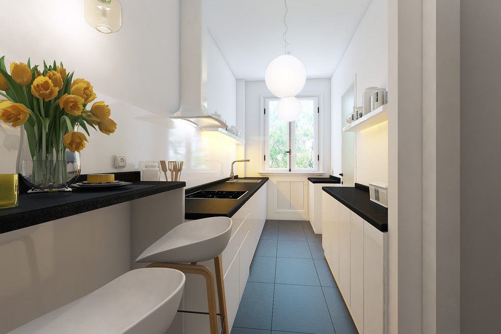 Immagine di una cucina parallela moderna chiusa e di medie dimensioni con lavello sottopiano, ante a filo, ante bianche, top in granito, paraspruzzi bianco, paraspruzzi con lastra di vetro, elettrodomestici neri e pavimento con piastrelle in ceramica