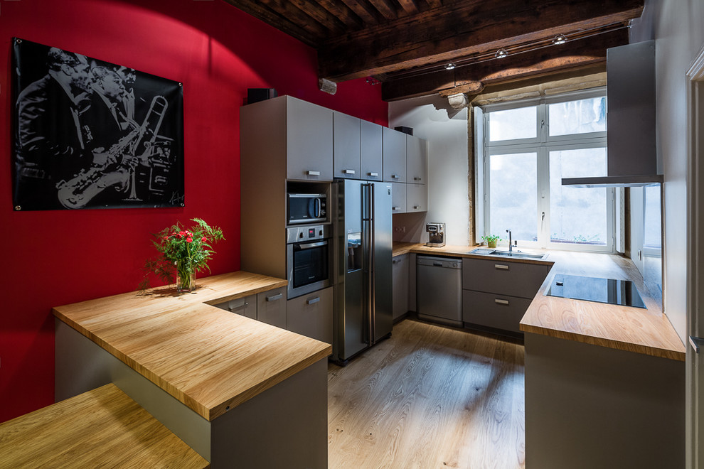 Mittelgroße Moderne Wohnküche in U-Form mit grauen Schränken und Halbinsel in Lyon