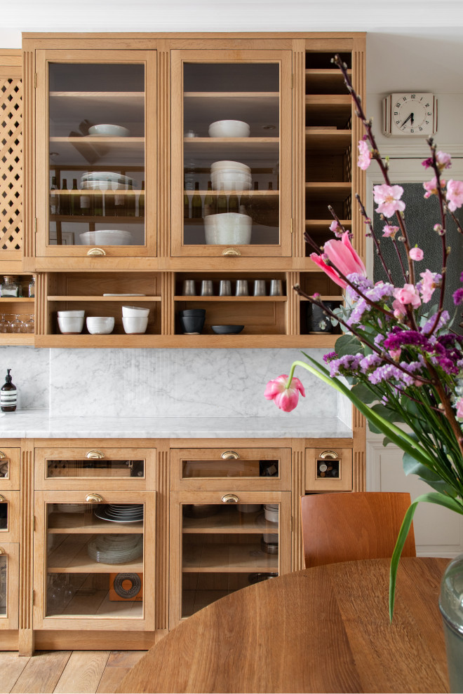 Medium sized classic galley kitchen in Paris with marble worktops, marble splashback, integrated appliances and medium hardwood flooring.
