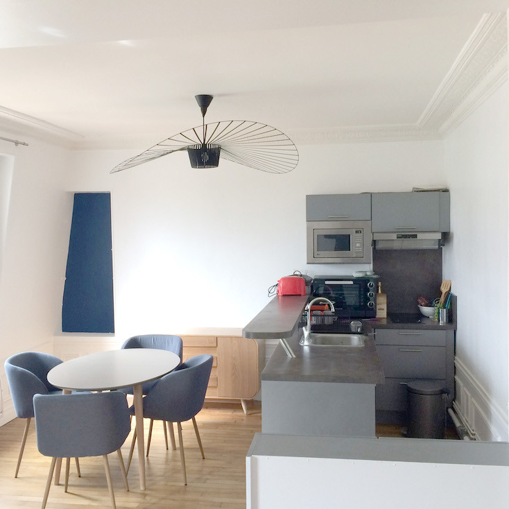 Contemporary kitchen in Rennes with light hardwood flooring.