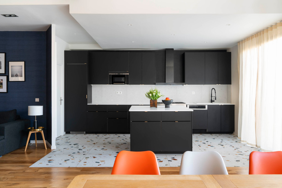Photo of a medium sized contemporary single-wall open plan kitchen in Paris with flat-panel cabinets, black cabinets, white splashback, integrated appliances, an island, multi-coloured floors and white worktops.