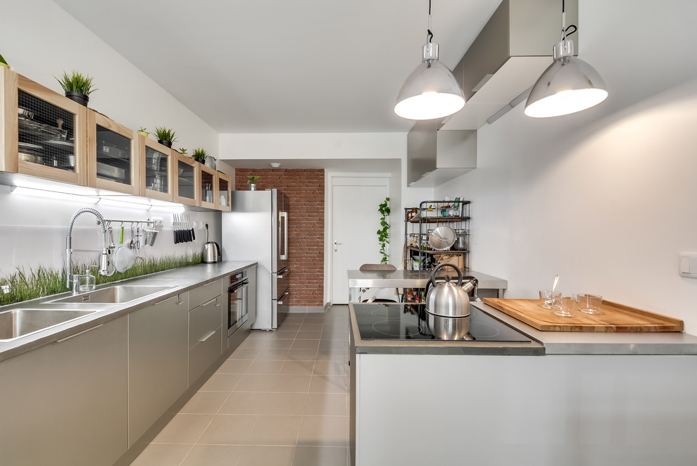 Design ideas for an industrial single-wall open plan kitchen in Paris with a submerged sink, concrete worktops, green splashback, glass sheet splashback, stainless steel appliances, ceramic flooring and grey floors.