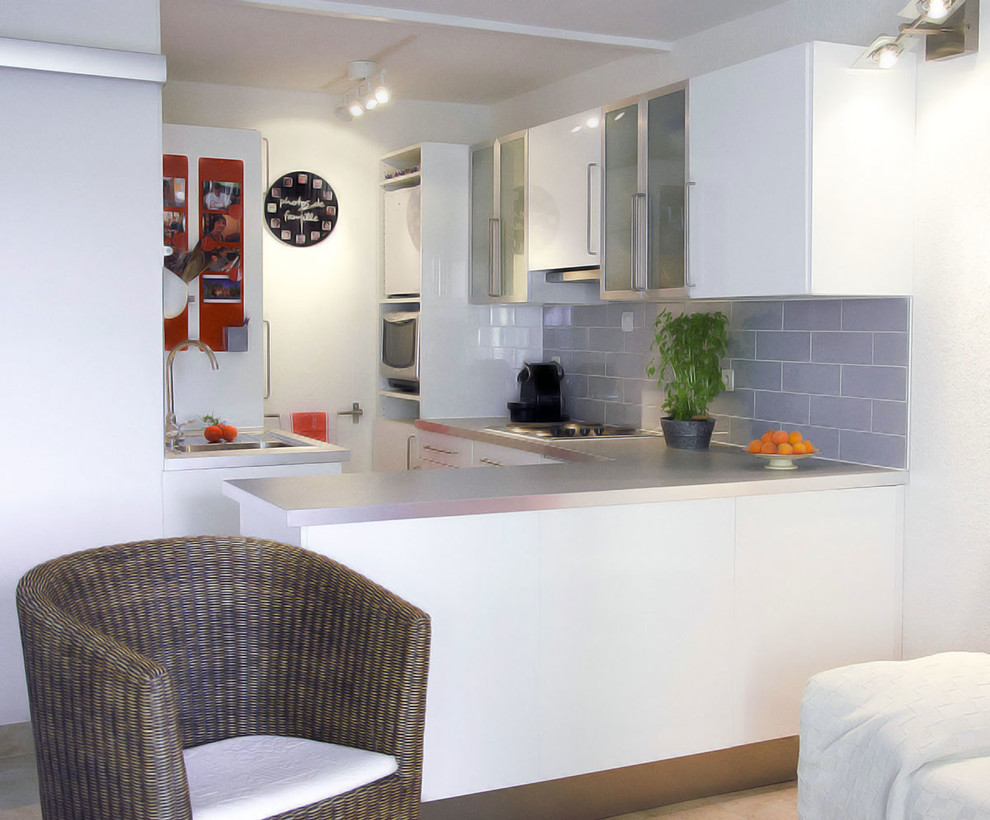 Small modern galley open plan kitchen in Other with a submerged sink, glass-front cabinets, white cabinets, laminate countertops, blue splashback, matchstick tiled splashback, ceramic flooring and a breakfast bar.