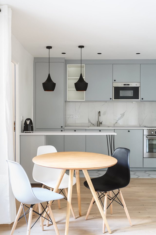 Photo of a small scandi single-wall open plan kitchen in Paris with a single-bowl sink, flat-panel cabinets, grey cabinets, laminate countertops, white splashback, ceramic splashback, stainless steel appliances, ceramic flooring, an island, white floors and white worktops.