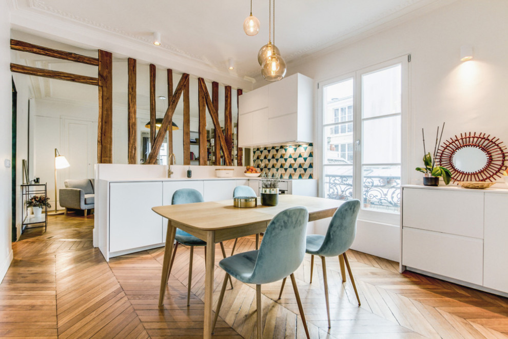 Medium sized contemporary single-wall open plan kitchen in Paris with a submerged sink, flat-panel cabinets, white cabinets, multi-coloured splashback, terracotta splashback, integrated appliances, light hardwood flooring, no island, brown floors and white worktops.