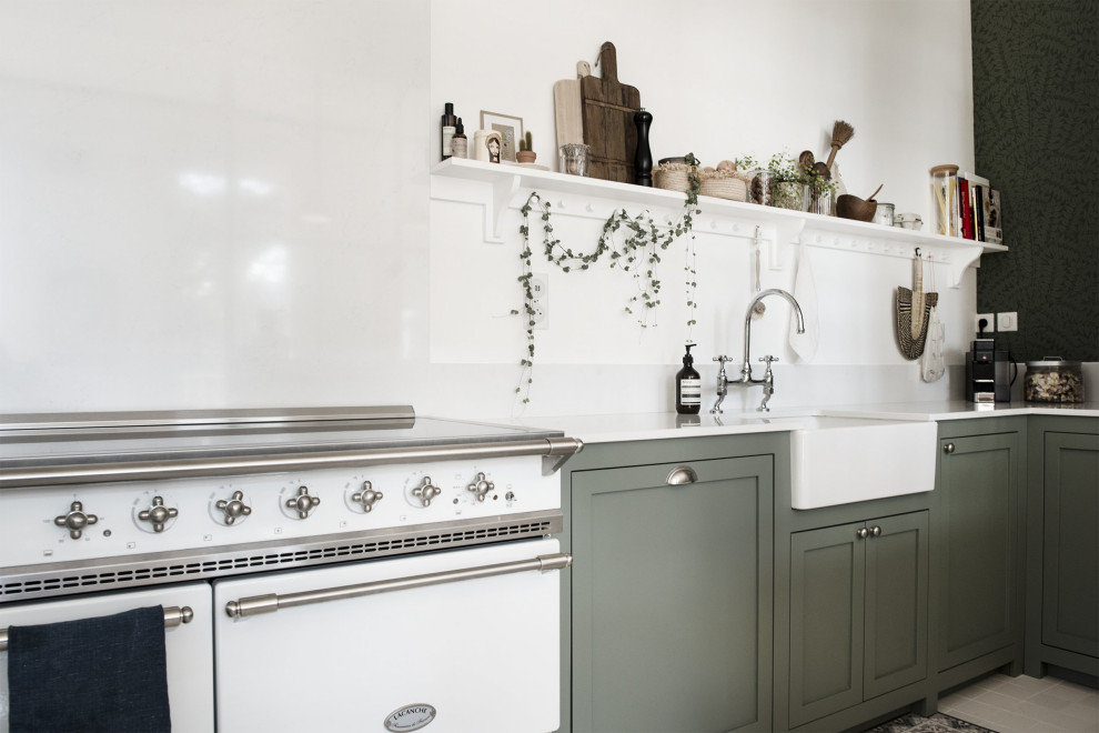 This is an example of a medium sized classic l-shaped kitchen/diner in Lyon with a single-bowl sink, beaded cabinets, green cabinets, marble worktops, white splashback, marble splashback, white appliances, cement flooring, an island, white floors and white worktops.