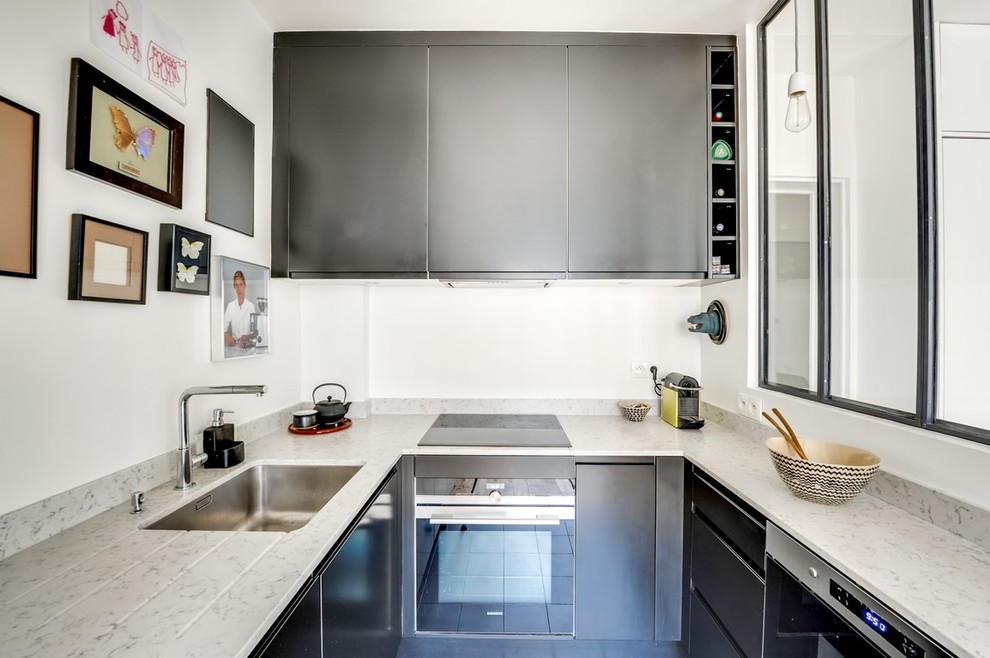 Inspiration for a small contemporary u-shaped kitchen remodel in Paris with quartzite countertops, paneled appliances, an undermount sink, flat-panel cabinets, black cabinets and no island