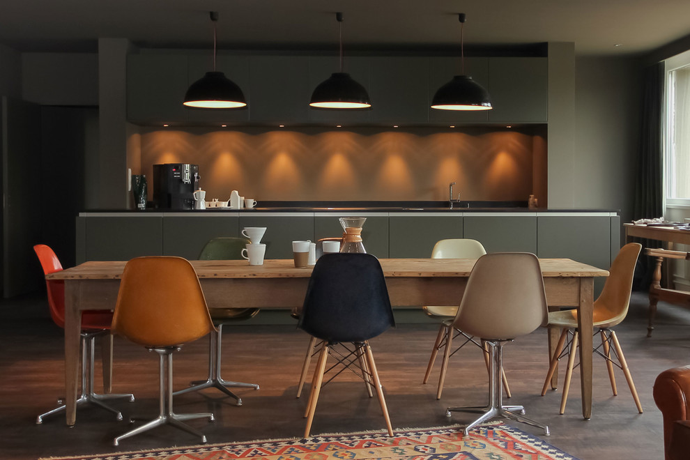 Inspiration for a large contemporary single-wall kitchen/diner in Strasbourg with flat-panel cabinets, grey cabinets, grey splashback, integrated appliances, dark hardwood flooring and an island.