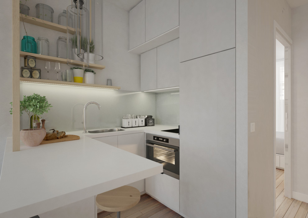 Idéer för ett litet modernt vit kök, med en integrerad diskho, luckor med profilerade fronter, vita skåp, laminatbänkskiva, vitt stänkskydd, stänkskydd i glaskakel, rostfria vitvaror, ljust trägolv och brunt golv