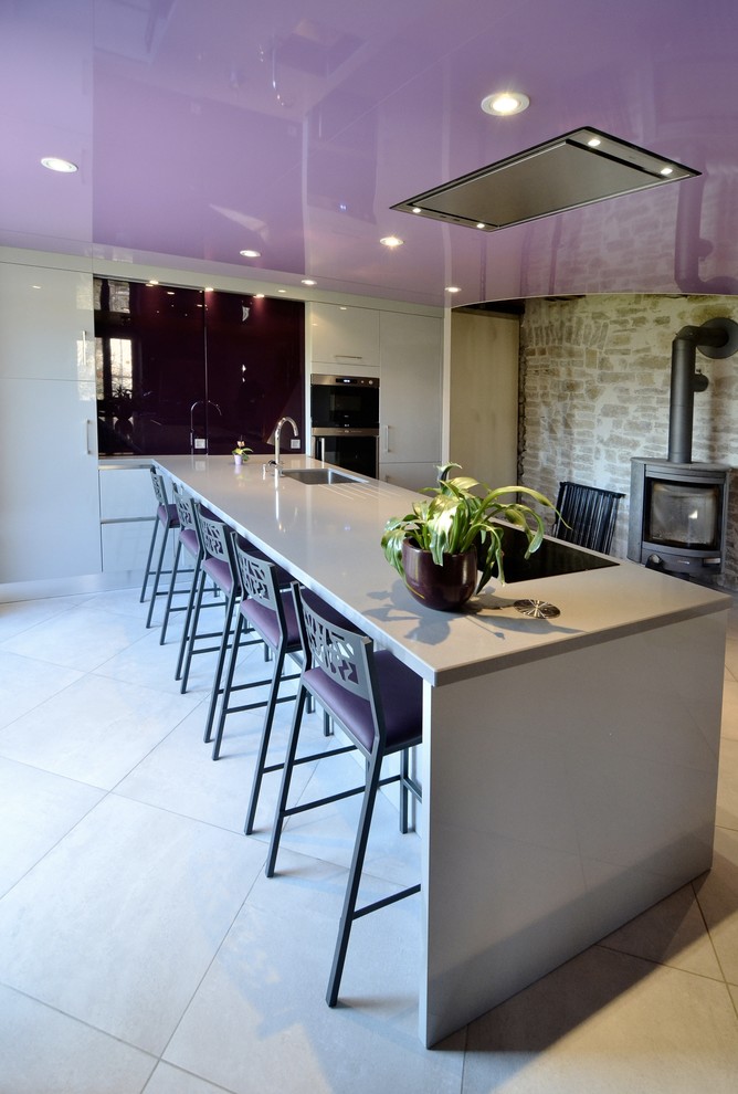 Design ideas for a large contemporary grey and purple single-wall kitchen/diner in Dijon with white cabinets and an island.