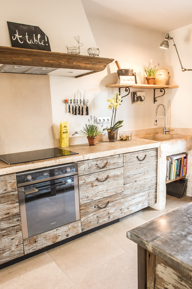 Inspiration for a medium sized bohemian single-wall enclosed kitchen in Other with distressed cabinets, beige splashback, a built-in sink, beaded cabinets, limestone worktops, limestone splashback, stainless steel appliances, limestone flooring, an island, beige floors and beige worktops.