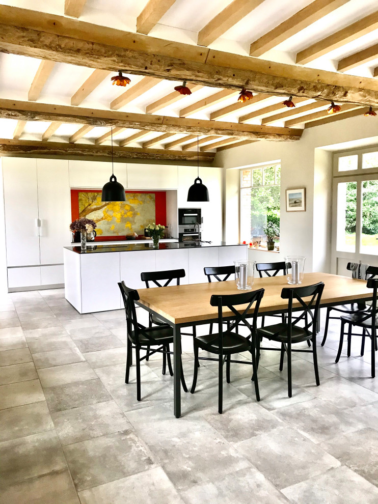 Photo of a large contemporary single-wall kitchen/diner in Paris with a single-bowl sink, white cabinets, multi-coloured splashback, integrated appliances, ceramic flooring, an island and grey floors.