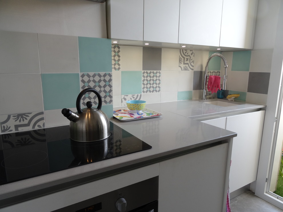Design ideas for a small modern single-wall enclosed kitchen in Marseille with an integrated sink, beaded cabinets, white cabinets, quartz worktops, multi-coloured splashback, cement tile splashback, stainless steel appliances, ceramic flooring, no island, grey floors and grey worktops.