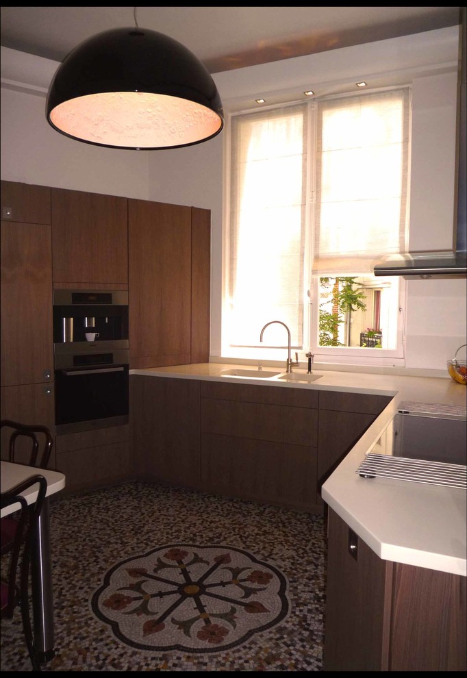 Photo of a small contemporary l-shaped kitchen in Other with a built-in sink, flat-panel cabinets and wood worktops.