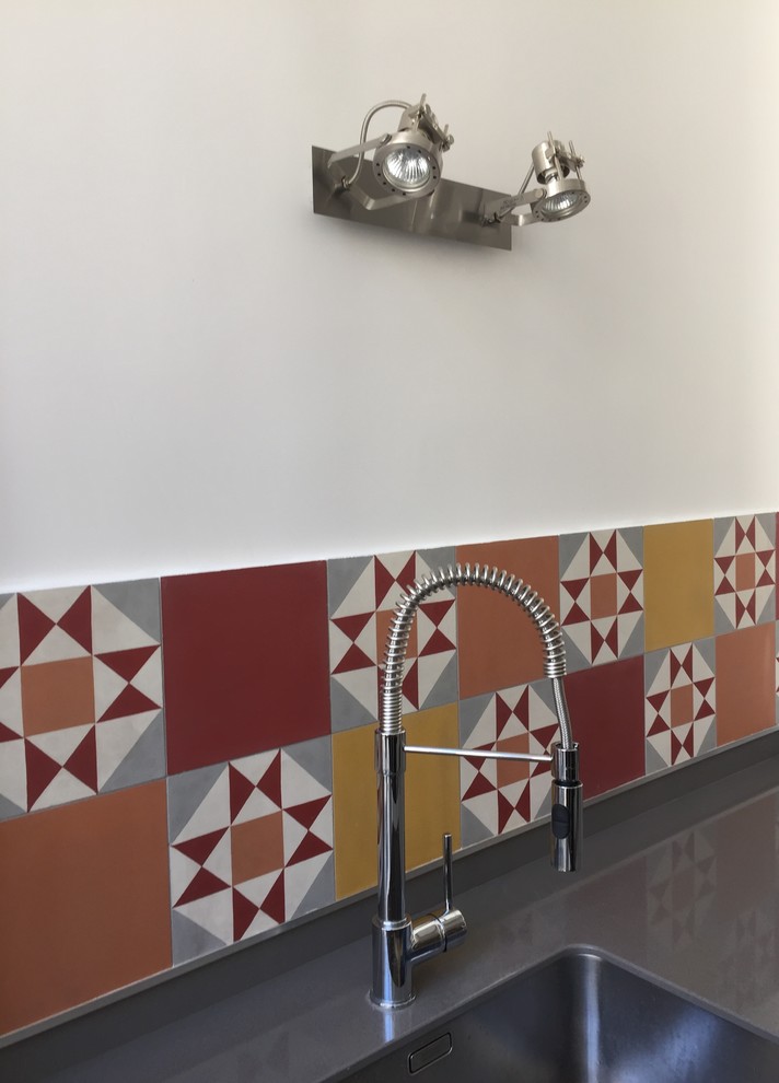 Medium sized bohemian single-wall open plan kitchen in Paris with red splashback and ceramic splashback.