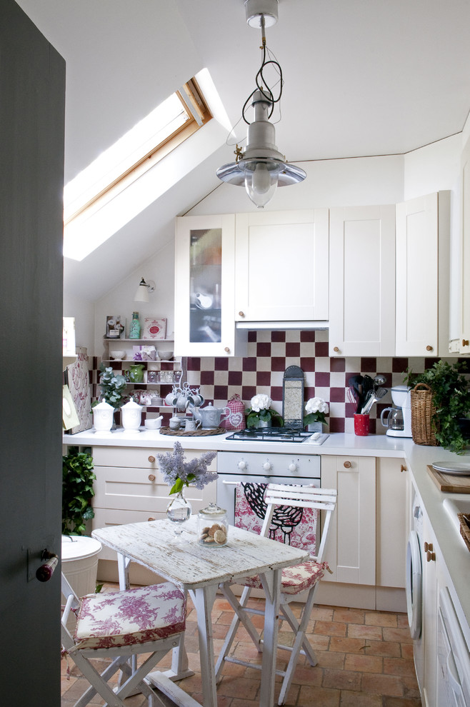 Modelo de cocina romántica pequeña con fregadero encastrado, armarios estilo shaker, puertas de armario blancas, salpicadero multicolor y electrodomésticos blancos