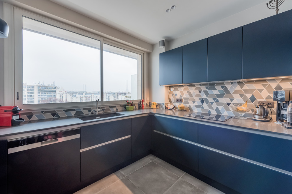 Esempio di una grande cucina minimal con lavello sottopiano, ante a persiana, paraspruzzi blu, paraspruzzi con piastrelle di cemento, elettrodomestici da incasso, pavimento grigio e top grigio