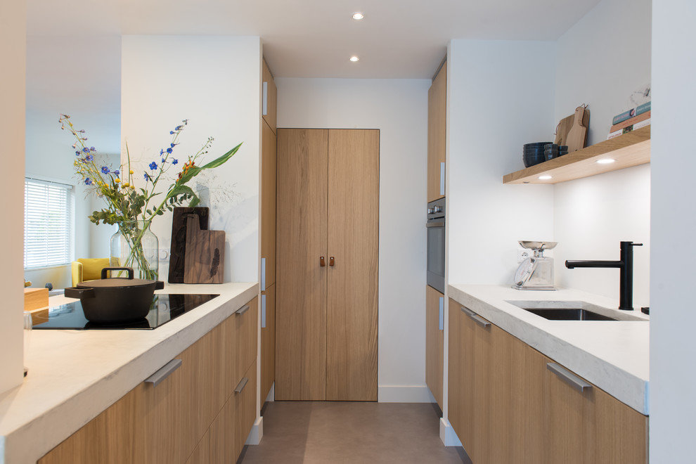 Example of a small danish single-wall concrete floor and gray floor open concept kitchen design in Amsterdam with an integrated sink, flat-panel cabinets, wood countertops, white backsplash, terra-cotta backsplash, stainless steel appliances, a peninsula and white countertops