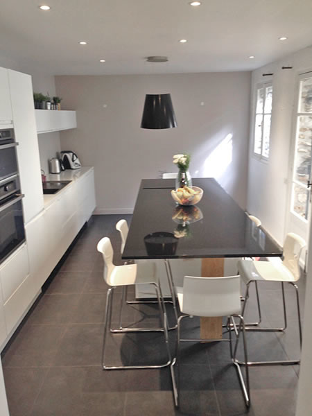 Design ideas for a large contemporary galley kitchen/diner in Other with a single-bowl sink, beaded cabinets, white cabinets, granite worktops, white splashback, glass sheet splashback, stainless steel appliances, ceramic flooring and an island.
