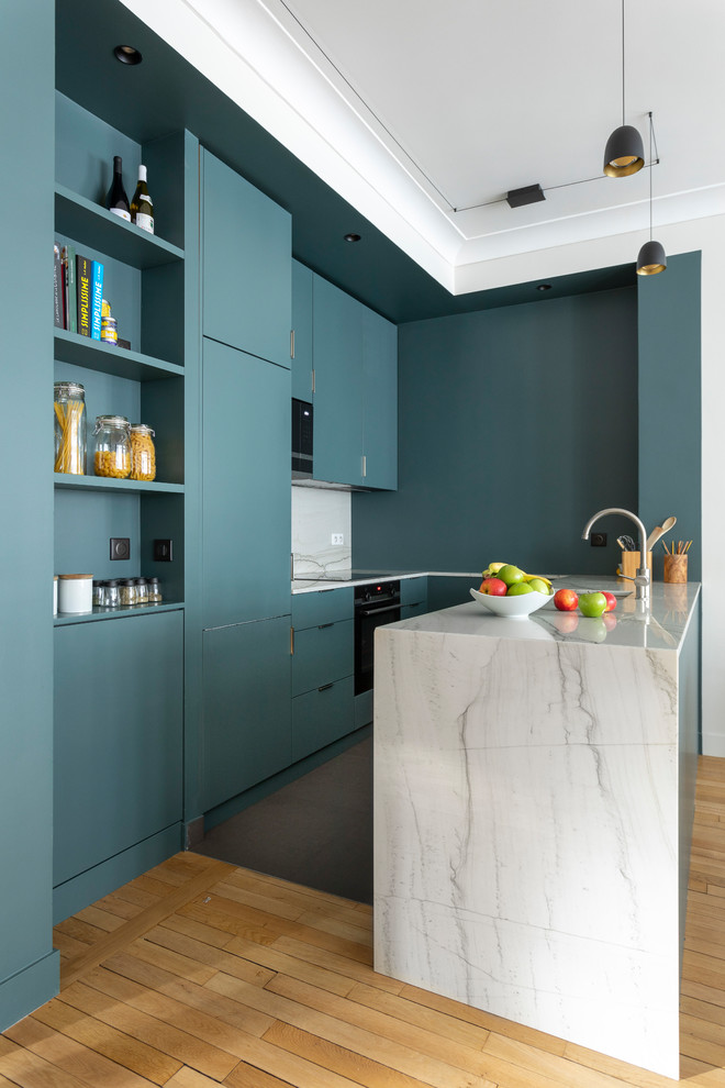 Kitchen - contemporary u-shaped light wood floor and beige floor kitchen idea in Paris with flat-panel cabinets, turquoise cabinets, white backsplash, stone slab backsplash, a peninsula and white countertops
