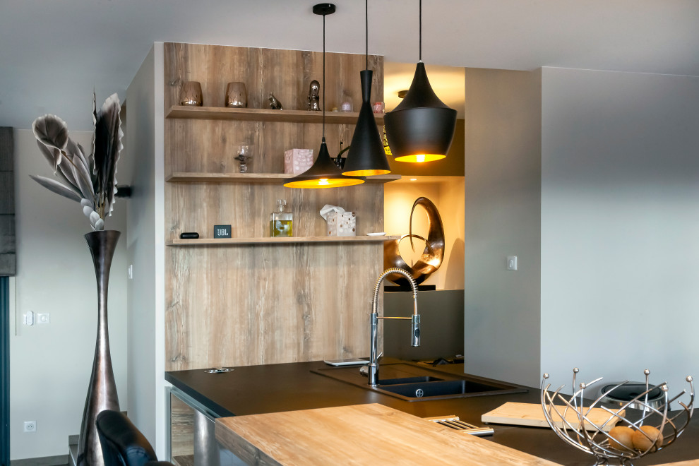 Inspiration for a large contemporary l-shaped kitchen in Lyon with multiple islands.