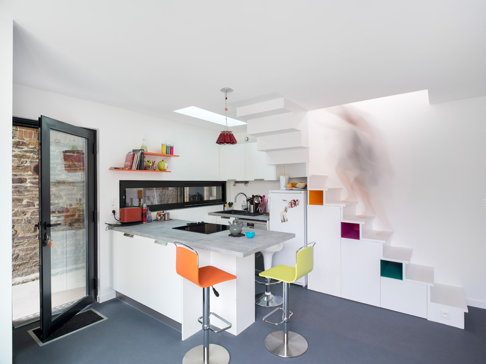 Идея дизайна: маленькая кухня-гостиная в современном стиле с серым полом, серой столешницей, накладной мойкой, плоскими фасадами, белыми фасадами и полуостровом для на участке и в саду