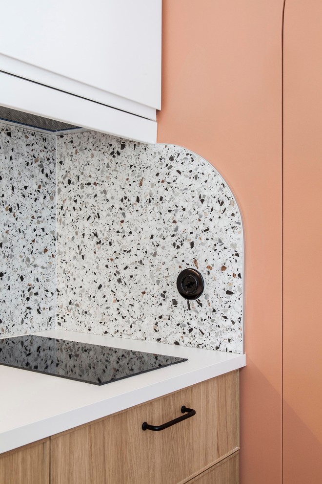Inspiration for a small modern single-wall terrazzo floor and multicolored floor open concept kitchen remodel in Paris with a single-bowl sink, beaded inset cabinets, light wood cabinets, laminate countertops, multicolored backsplash, ceramic backsplash, paneled appliances and white countertops
