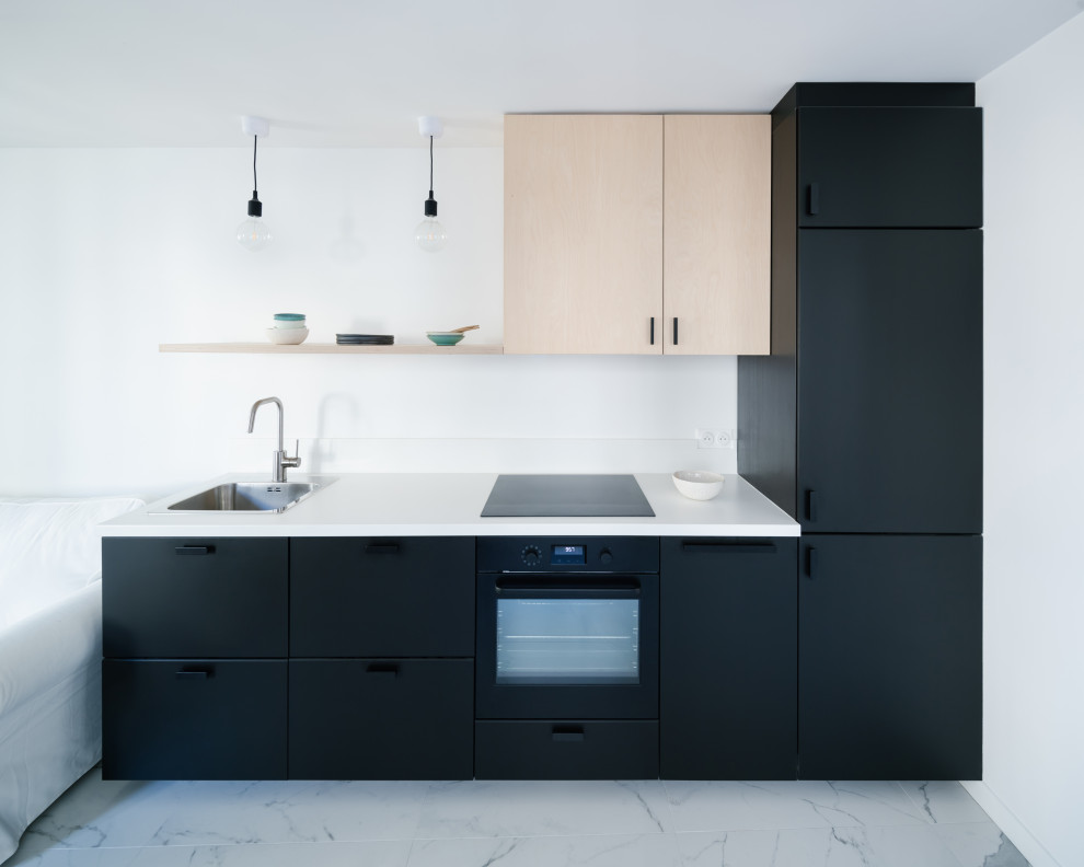 Small danish single-wall ceramic tile and white floor eat-in kitchen photo in Paris with an undermount sink, beaded inset cabinets, black cabinets, laminate countertops, white backsplash and white countertops