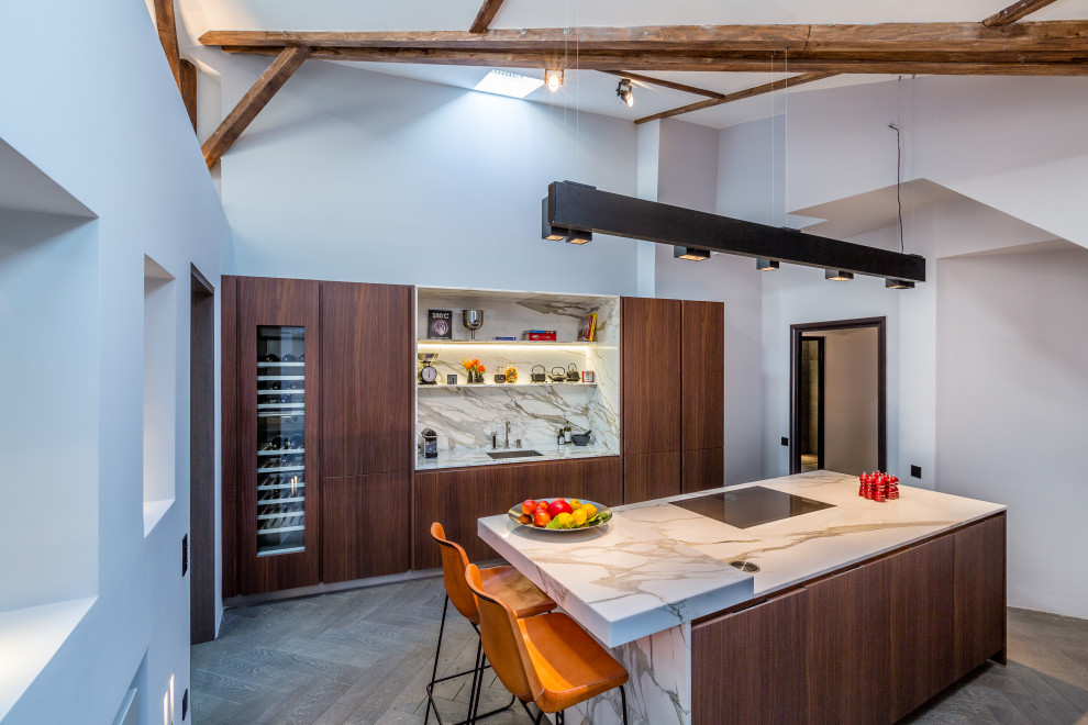Trendy brown floor, exposed beam and vaulted ceiling kitchen photo in Paris with a single-bowl sink, flat-panel cabinets, dark wood cabinets, multicolored backsplash, stone slab backsplash, paneled appliances, an island and multicolored countertops