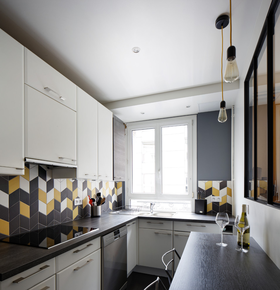 パリにある中くらいなコンテンポラリースタイルのおしゃれなL型キッチン (白いキャビネット、ラミネートカウンター、黄色いキッチンパネル、セラミックタイルのキッチンパネル、シルバーの調理設備) の写真