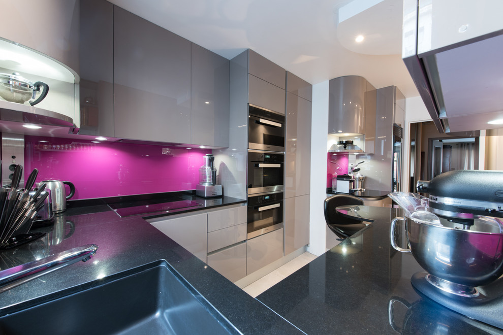 Photo of a contemporary kitchen in Paris with a submerged sink, granite worktops, integrated appliances and ceramic flooring.