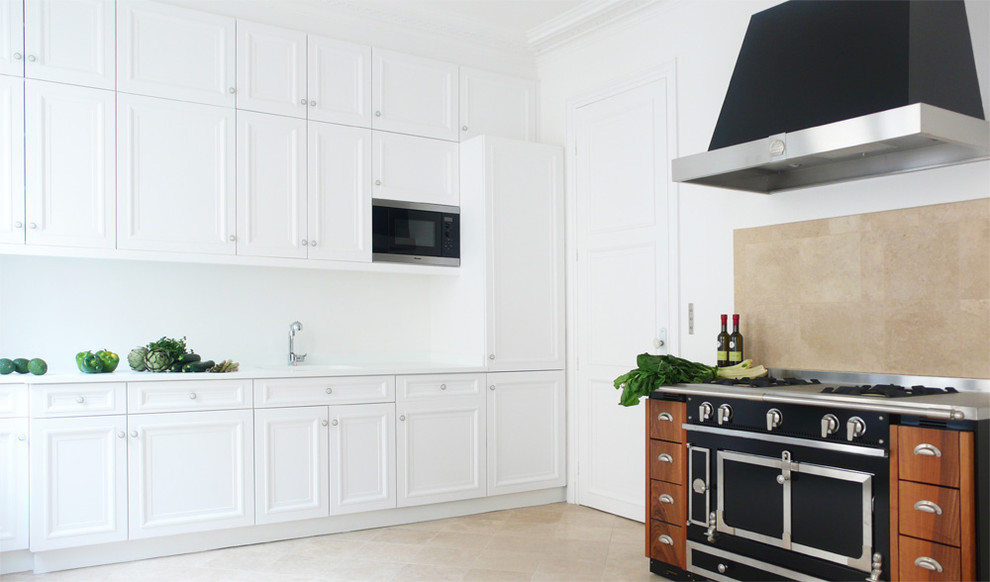 Inspiration for a mid-sized timeless single-wall enclosed kitchen remodel in Paris with recessed-panel cabinets, white cabinets, beige backsplash, black appliances and no island