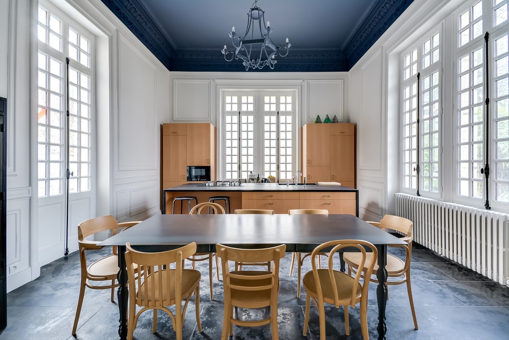 Inspiration for a large traditional galley kitchen/diner in Paris with flat-panel cabinets, medium wood cabinets and an island.
