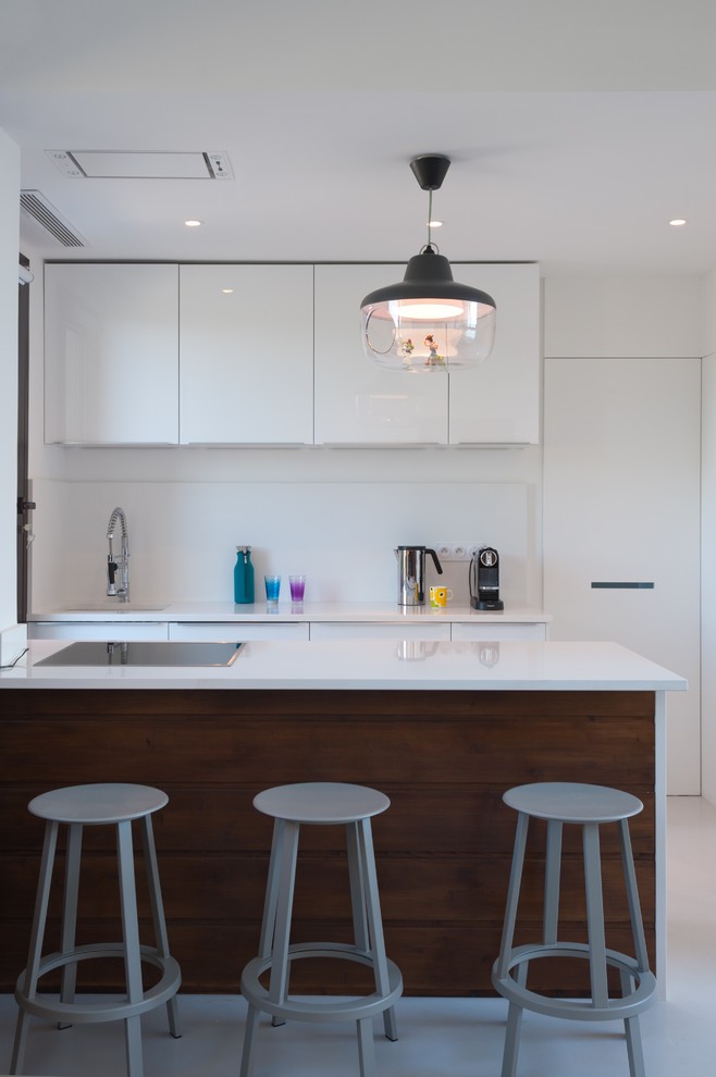 Inspiration for a small scandinavian galley eat-in kitchen remodel in Corsica with flat-panel cabinets, white cabinets, white backsplash and a peninsula