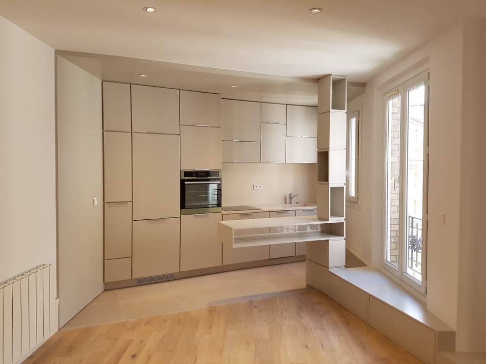Design ideas for a medium sized contemporary single-wall kitchen/diner in Paris with an integrated sink, flat-panel cabinets, grey cabinets, quartz worktops, beige splashback, integrated appliances, ceramic flooring and a breakfast bar.