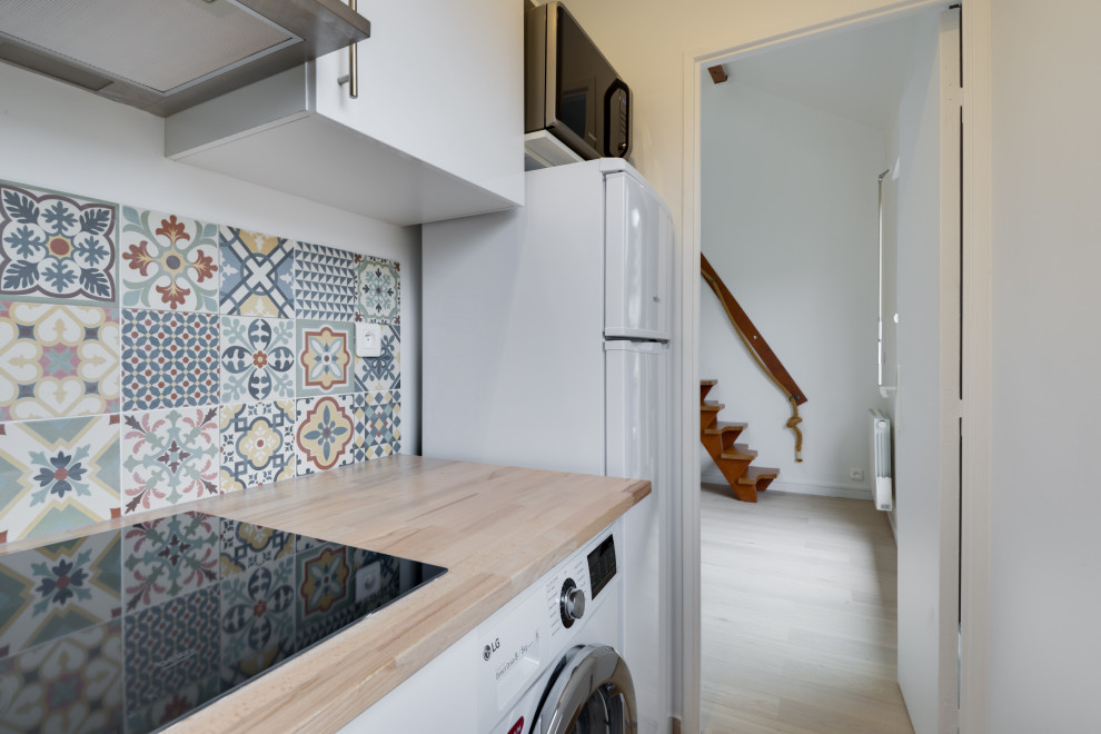 Foto de cocinas en L contemporánea pequeña con fregadero integrado, encimera de madera, salpicadero de azulejos de cemento y electrodomésticos blancos